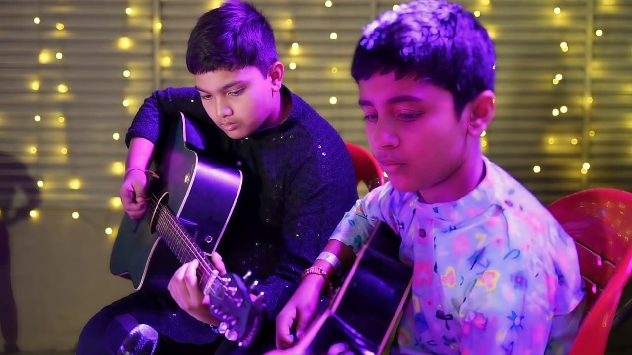 Young boys learning guitar